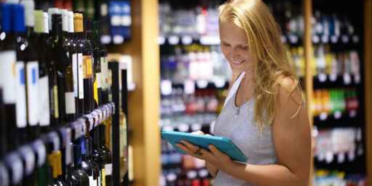 Woman choosing wine using pad